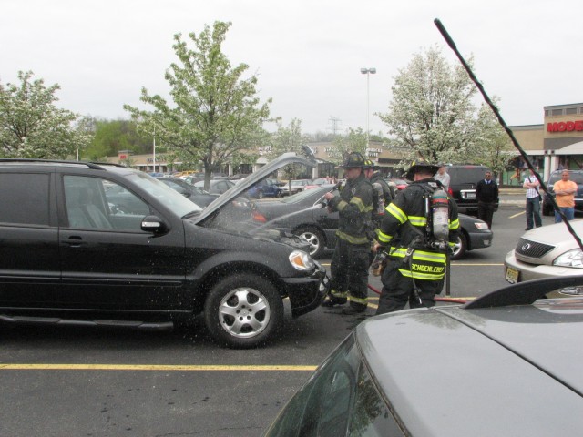 NFD members chase down a stubborn car fire.