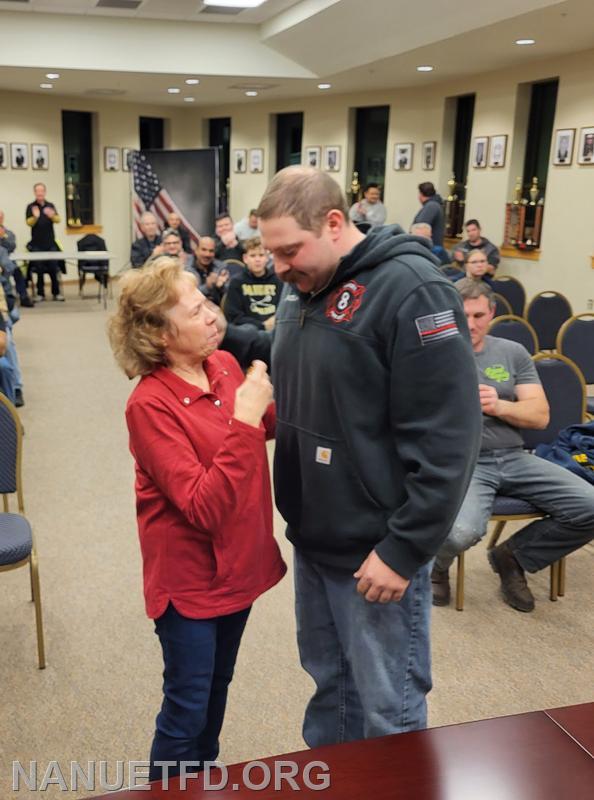 Mom pins her son with his new Badge. 8-1.