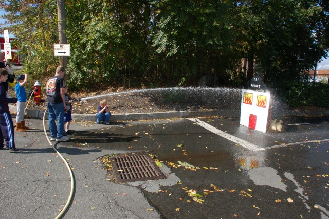 Children take their turn with a real fire hose at the NFD open house, 10/11/09.  Photo:  Tommy Bierds