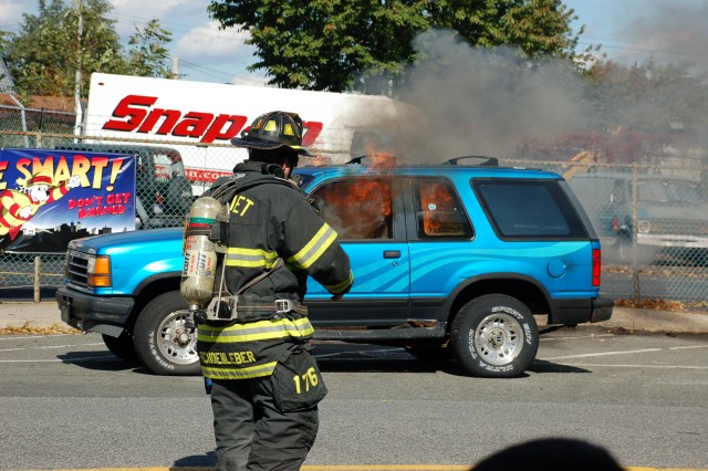 Lt Bill Schoenleber supervises a car fire demonstration at the NFD open house, 10/11/09.  Photo:  Tommy Bierds