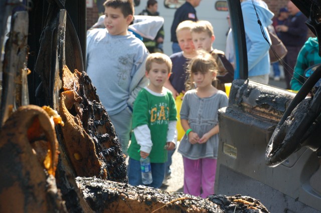 Children examine the aftermath of a demonstration car fire at the NFD open house, 10/11/09.  Photo:  Tommy Bierds