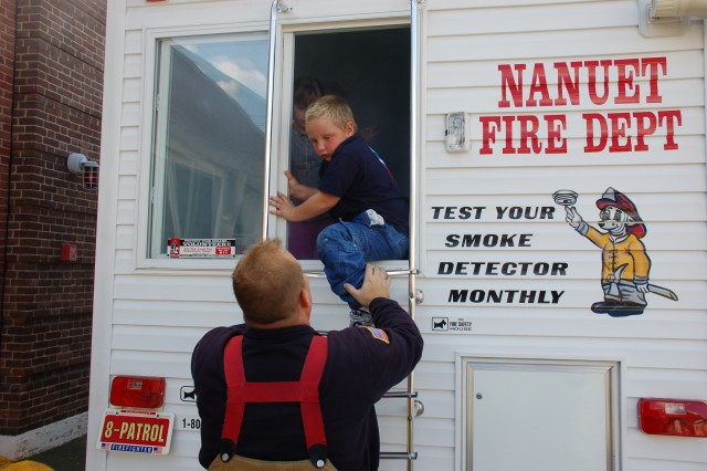 Andrew Knapp practices his escape technique at the NFD open house, 10/11/09.  Photo:  Tommy Bierds