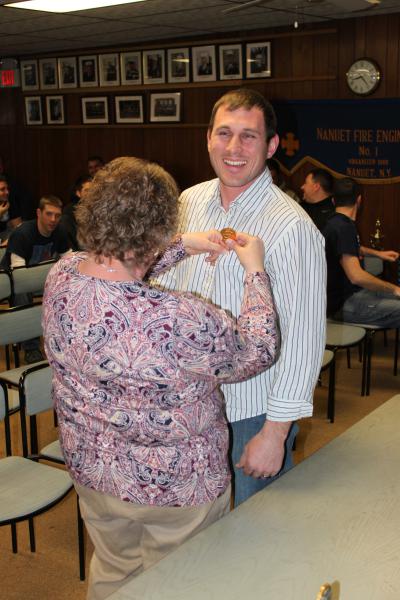 A very proud moment as Todd Giraudin receives his Chief's Badge from his mother January 8, 2015. Following in his Dad's footsteps. Ernest Giraudin. Chief 1994-1995
