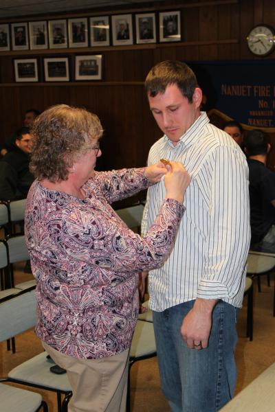 A very proud moment as Todd Giraudin receives his Chief's Badge from his mother January 8, 2015. Following in his Dad's footsteps. Ernest Giraudin. Chief 1994-1995

